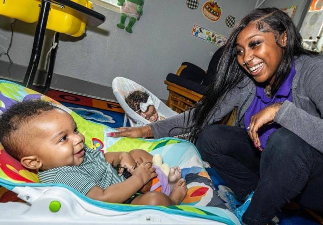 Infant teacher A’Aliyah Rhodes cares for infants Krue Williams, 4 months, and Jaela Bouck, 3 months, at the Sunrise Early Learning and Development Center in Fort Worth on Thursday.