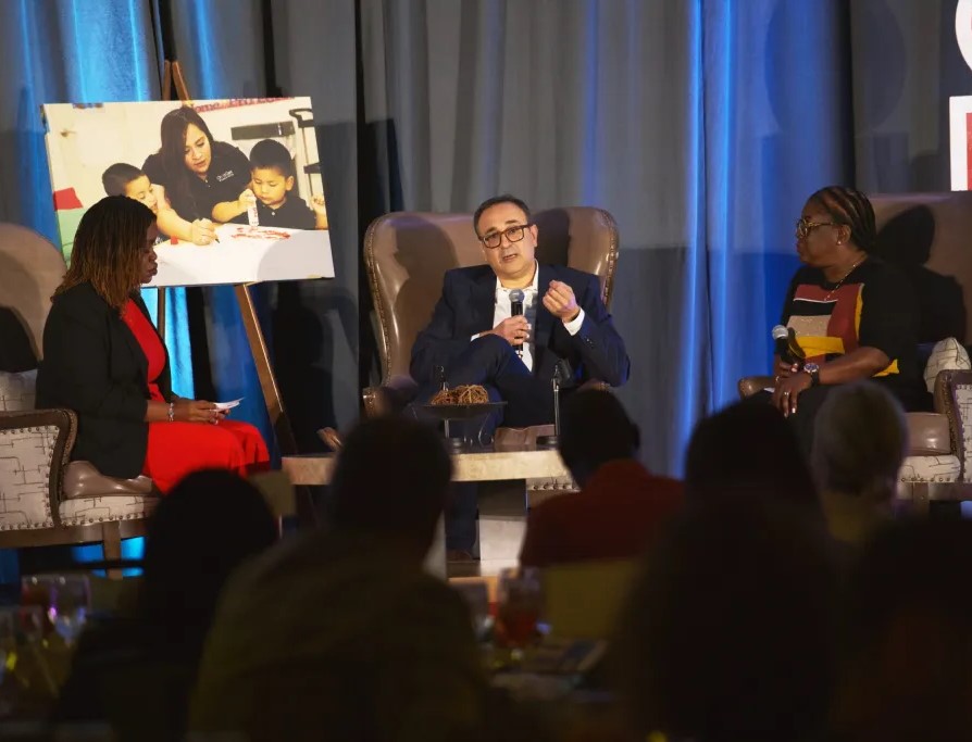 Economist Flávio Cunha, center, talks during a panel discussion at Child Care Associates’ annual investors’ luncheon Oct. 11, 2023, in the Omni Fort Worth Hotel downtown. Shawneequa Blount, director of child care innovation at the Institute to Advance Child Care, left, and Felicia Davis, owner of Ready Set Jump Learning Center, listen.